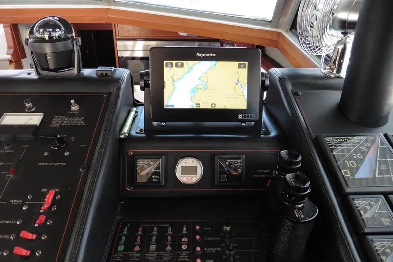 Slide: The Image of Control panel of a 1988 Bayliner 3888 Motoryacht with navigation equipment and gauges. - 36
