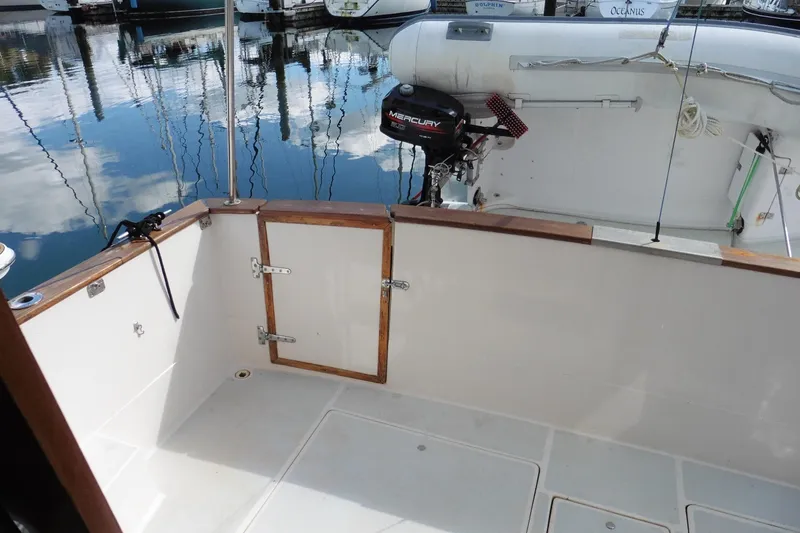 Slide: The Image of 1988 Bayliner 3888 Motoryacht deck with Mercury outboard motor, docked at marina. - 37