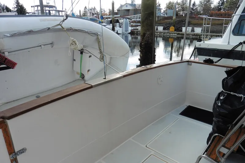 Slide: The Image of 1988 Bayliner 3888 Motoryacht docked, showcasing spacious deck and marina background. - 38