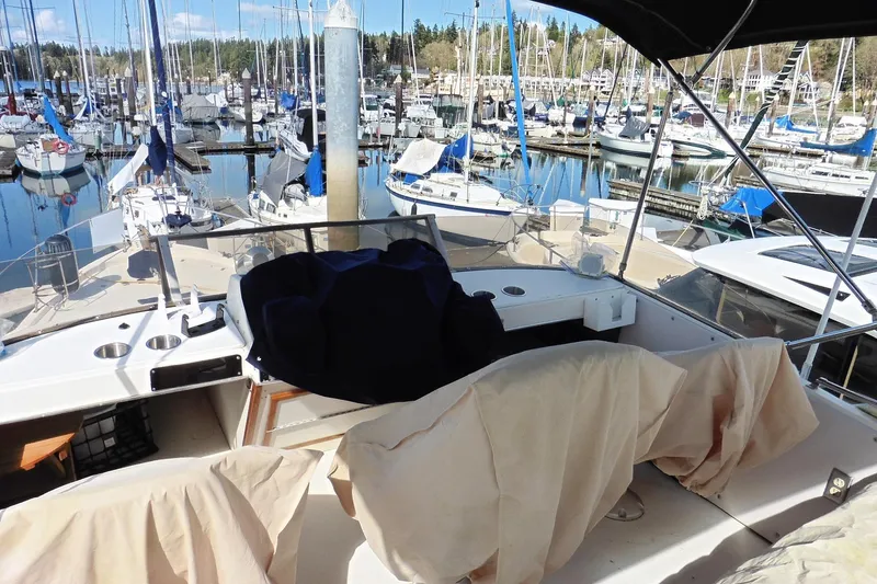 Slide: The Image of 1988 Bayliner 3888 Motoryacht docked in a marina, surrounded by sailboats. - 40