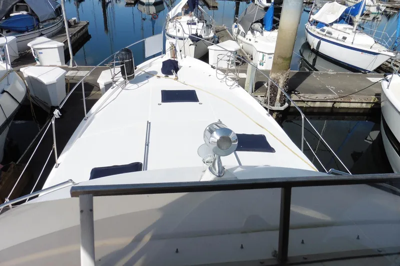 Slide: The Image of 1988 Bayliner 3888 Motoryacht docked at marina, showcasing spacious deck and sleek design. - 41