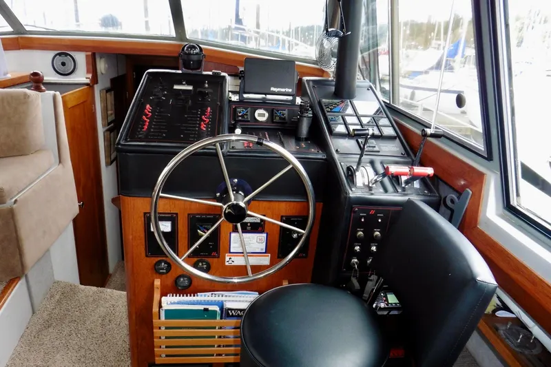Slide: The Image of Interior helm of 1988 Bayliner 3888 Motoryacht with steering wheel and navigation controls. - 6