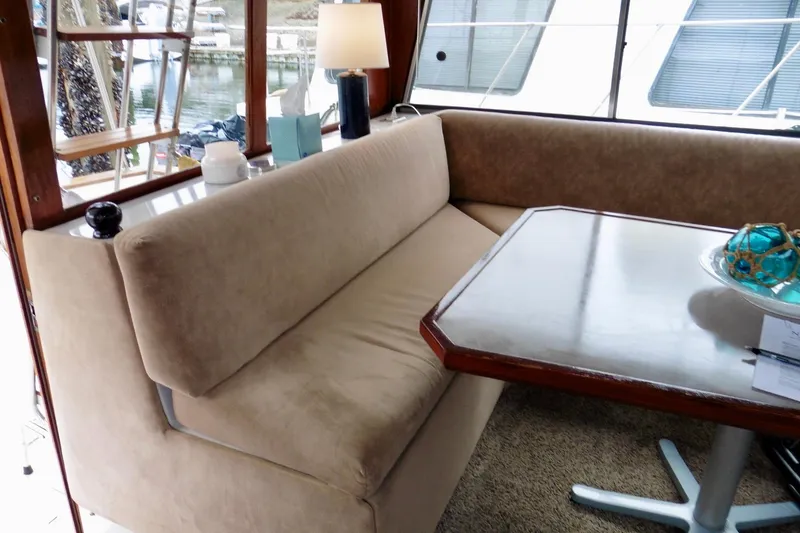 Slide: The Image of Interior of 1988 Bayliner 3888 Motoryacht with cozy seating and wooden table. - 8