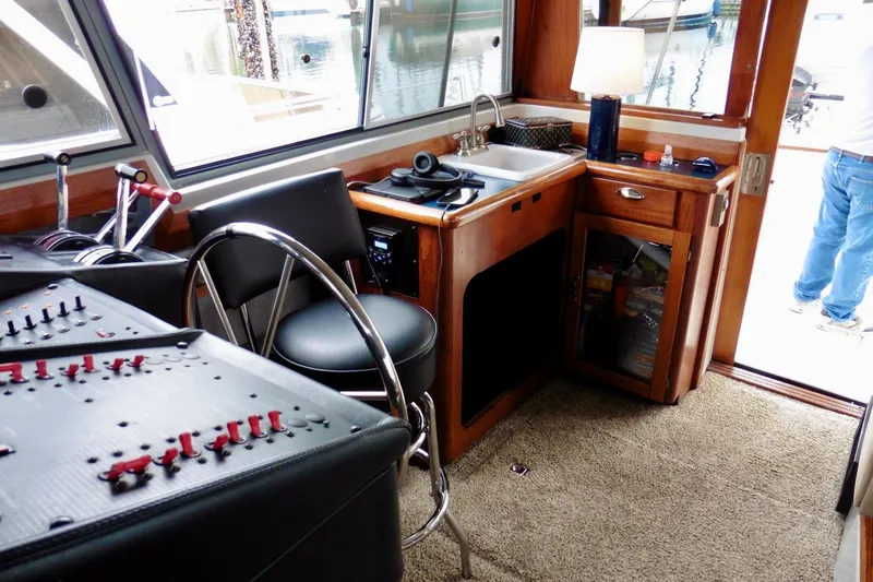 Slide: The Image of Interior of 1988 Bayliner 3888 Motoryacht with helm, controls, and kitchenette. - 9