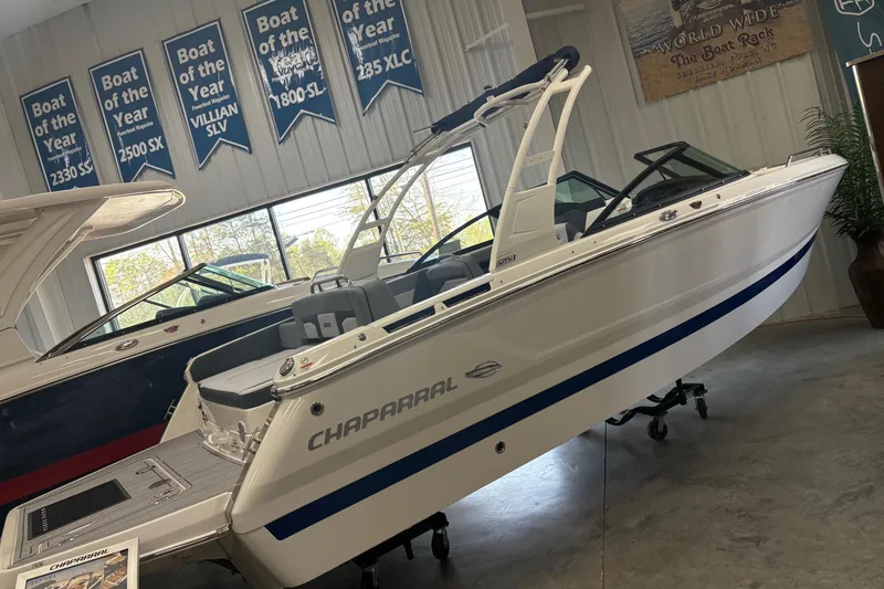 The Image of 2026 Chaparral SSX 4 boat displayed indoors with award banners above. - 0