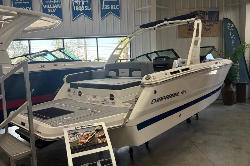 Slide: The Image of 2026 Chaparral SSX 4 boat displayed in showroom, featuring sleek design and modern amenities. - 2