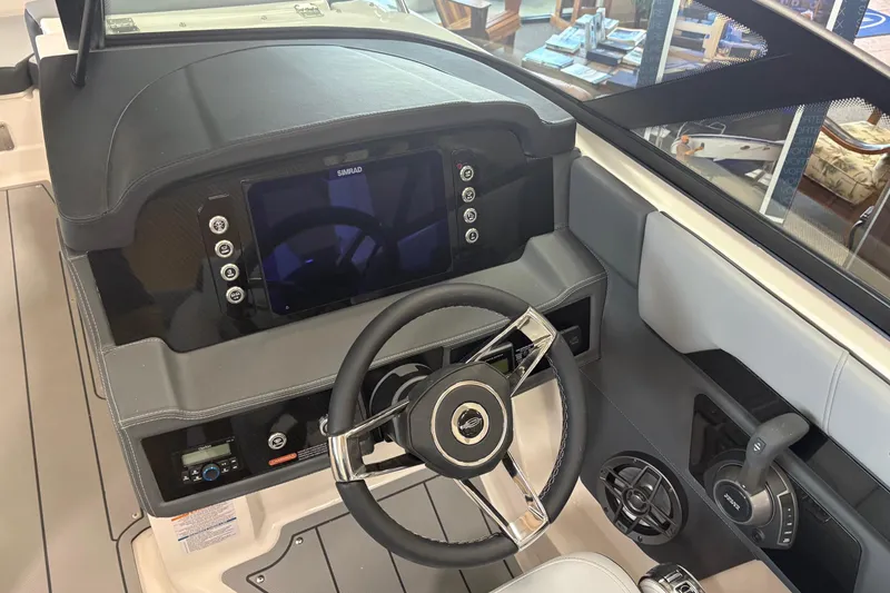 Slide: The Image of 2026 Chaparral SSX 4 boat dashboard with steering wheel and navigation display. - 4