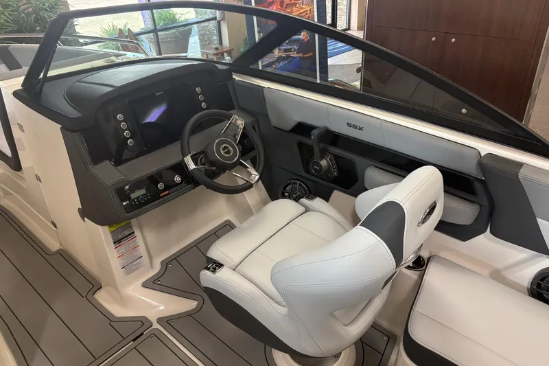 Slide: The Image of 2026 Chaparral SSX 4 boat interior with modern dashboard and sleek steering wheel design. - 8