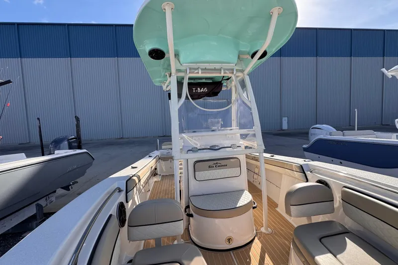 Slide: The Image of 2021 Sea Chaser 22 HFC boat with seating and console, docked outdoors. - 18