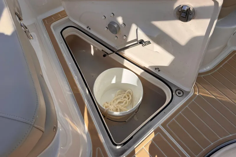 Slide: The Image of Storage compartment on a 2021 Sea Chaser 22 HFC boat with a bucket and rope. - 19