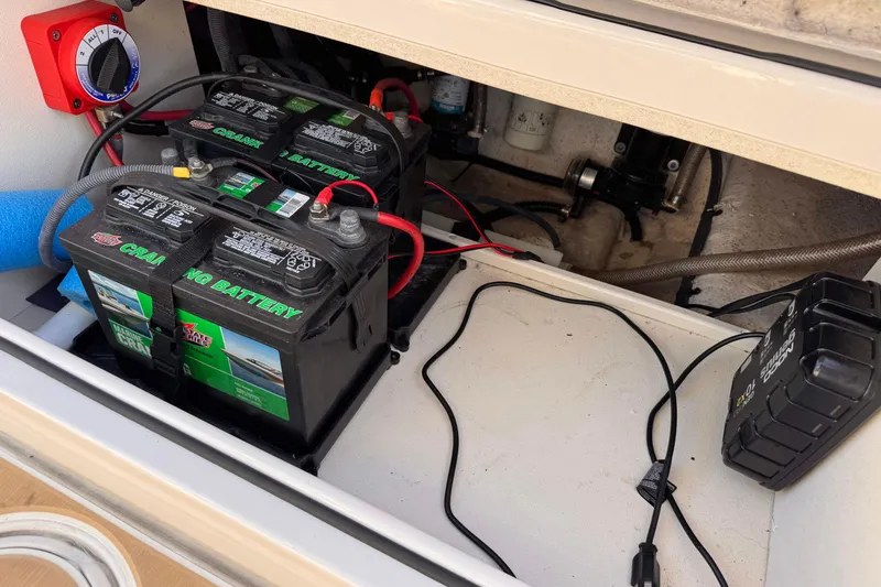 Slide: The Image of Battery compartment of a 2021 Sea Chaser 22 HFC boat, featuring dual marine batteries. - 20