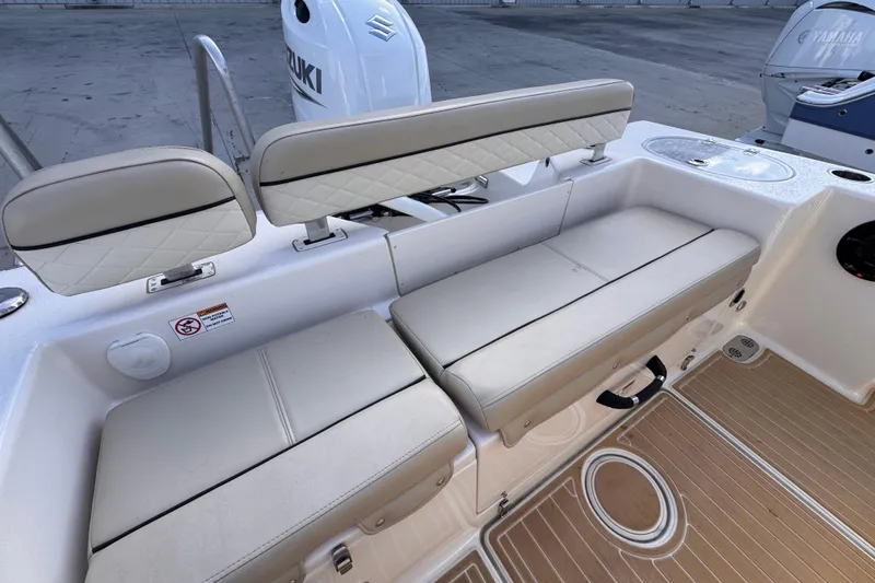 Slide: The Image of 2021 Sea Chaser 22 HFC boat interior with cushioned seating and Suzuki engine. - 7
