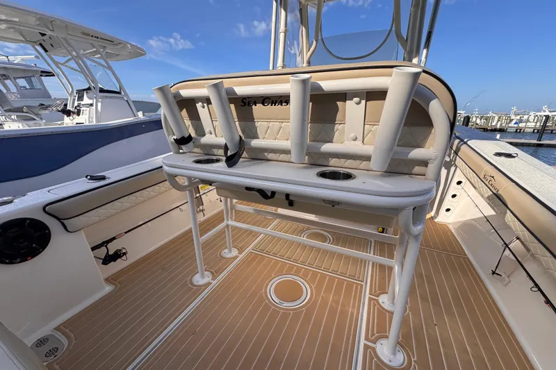 Slide: The Image of 2021 Sea Chaser 22 HFC boat interior with rod holders and seating, docked at marina. - 8