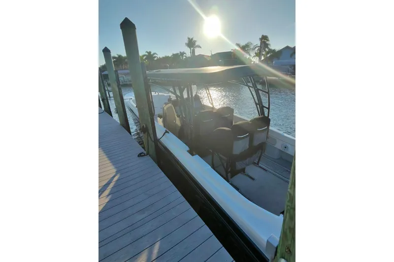 Slide: The Image of 2009 Nor-Tech 4400 Roadster docked at sunset, with sleek design and shaded seating. - 10