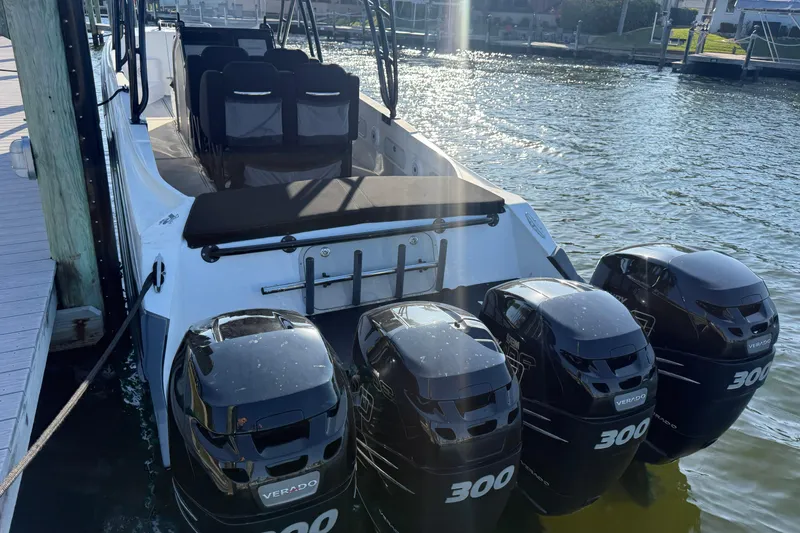 Slide: The Image of 2009 Nor-Tech 4400 Roadster with four powerful outboard engines docked by the water. - 11