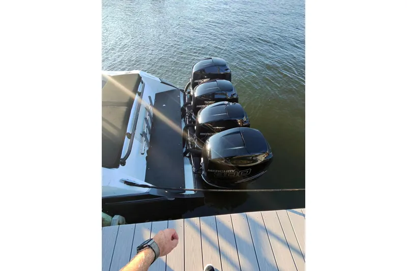 Slide: The Image of 2009 Nor-Tech 4400 Roadster with four Mercury 300 engines docked on water. - 12