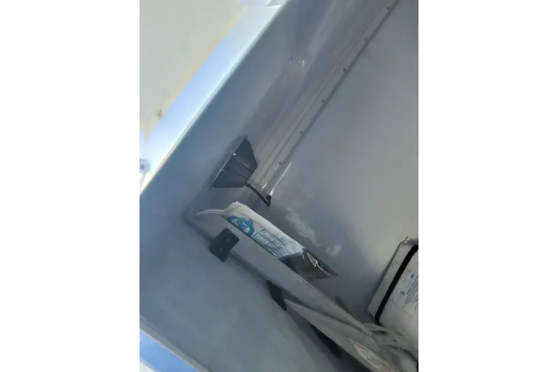 Slide: The Image of Storage compartment inside 2009 Nor-Tech 4400 Roadster boat, featuring equipment and supplies. - 18