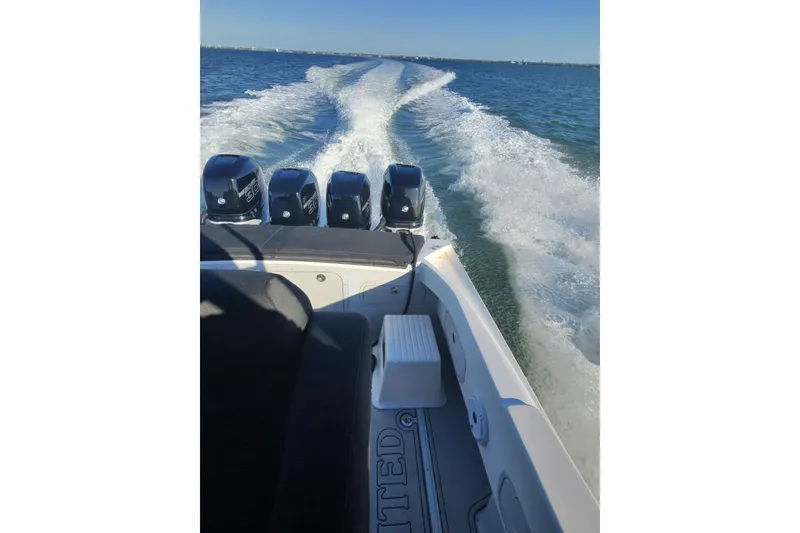 Slide: The Image of 2009 Nor-Tech 4400 Roadster speeding on open water, leaving a wake trail. - 21