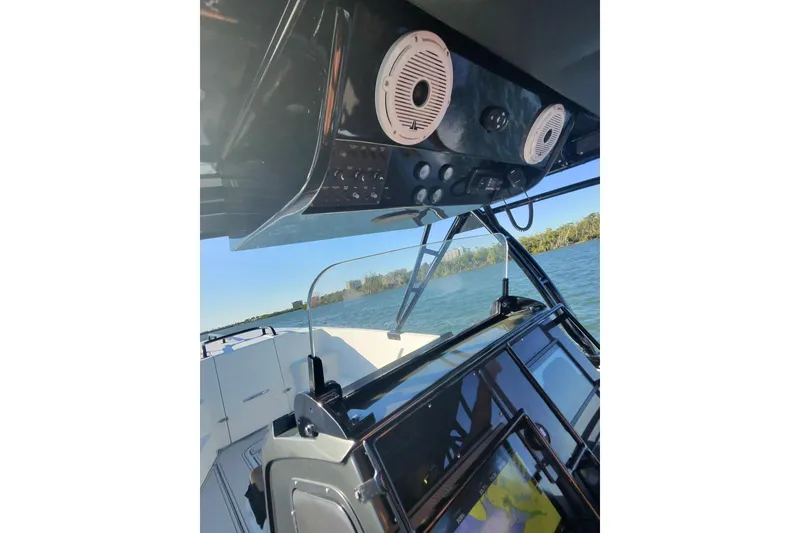 Slide: The Image of 2009 Nor-Tech 4400 Roadster cockpit with speakers, dashboard, and water view. - 25