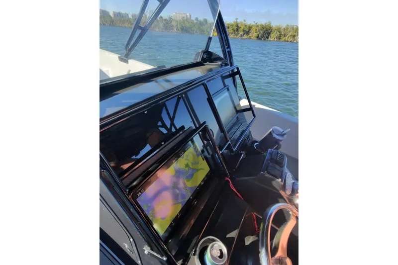 Slide: The Image of 2009 Nor-Tech 4400 Roadster dashboard with navigation screens on a sunny day. - 26