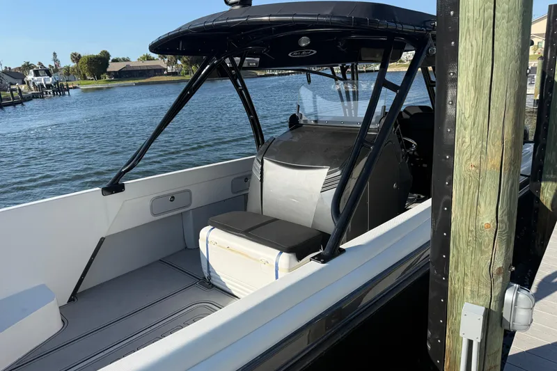 Slide: The Image of 2009 Nor-Tech 4400 Roadster boat docked by the water, showcasing sleek interior design. - 6