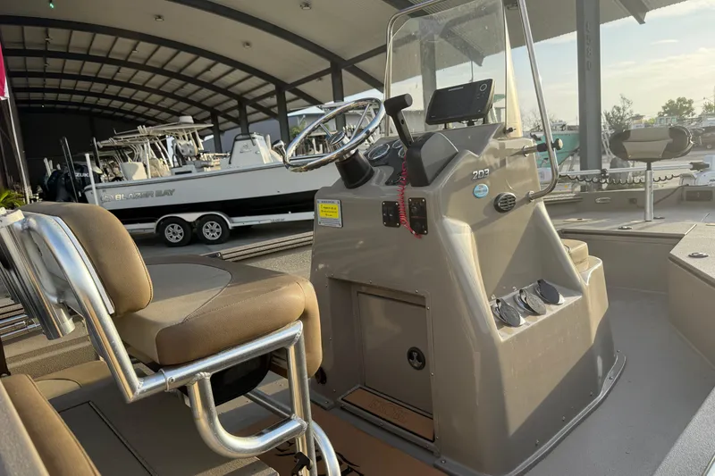 Slide: The Image of 2022 Excel 203 Bay Pro boat interior with steering console and seating. - 10
