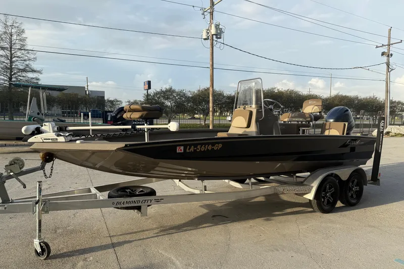 Slide: The Image of 2022 Excel 203 Bay Pro boat on trailer, parked outdoors, side view. - 4