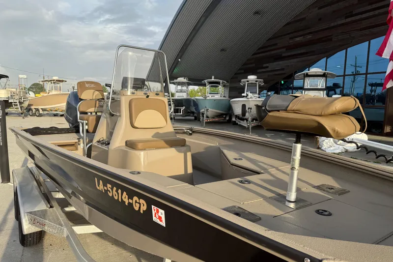 Slide: The Image of 2022 Excel 203 Bay Pro boat on trailer, parked outdoors near other boats. - 6
