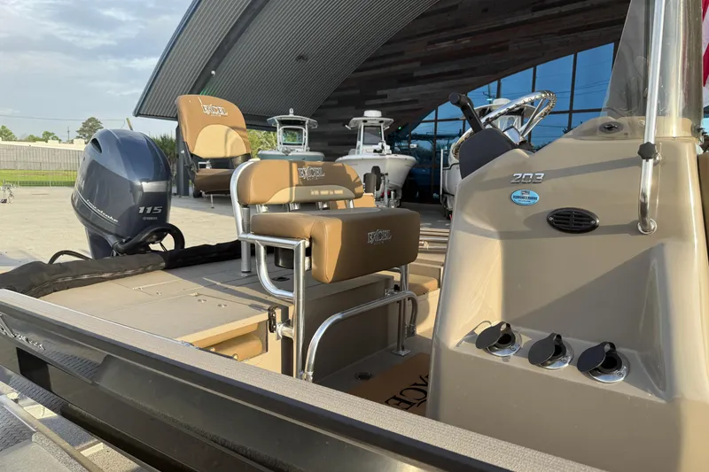 Slide: The Image of 2022 Excel 203 Bay Pro boat with Yamaha 115 engine, showcased outdoors. - 7