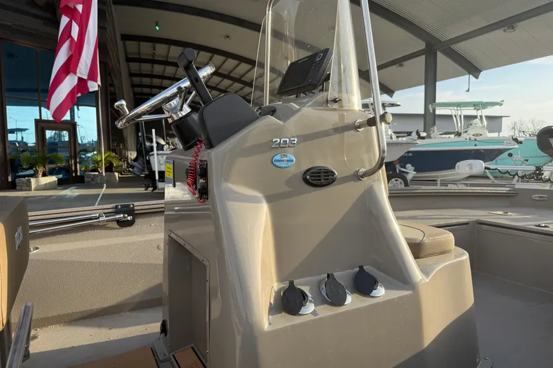 Slide: The Image of 2022 Excel 203 Bay Pro boat console with steering wheel and controls. - 8