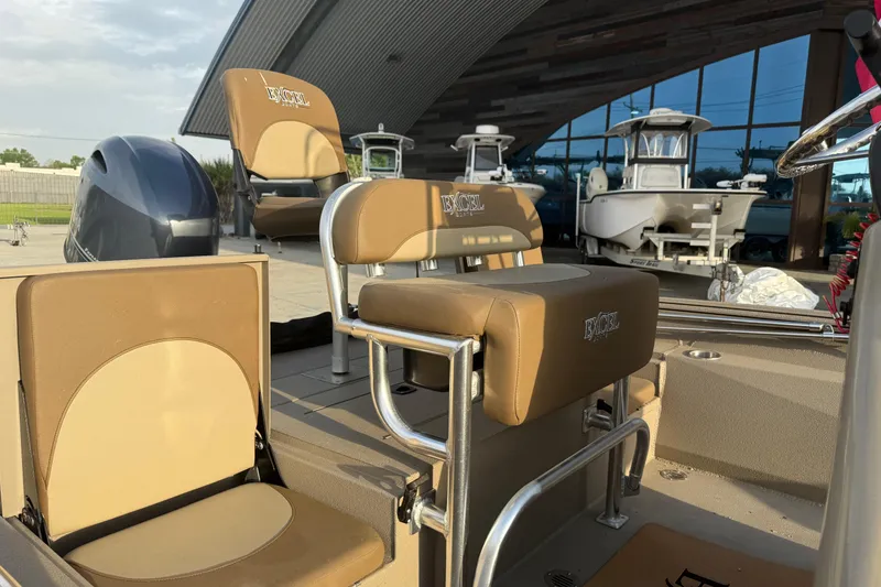 Slide: The Image of 2022 Excel 203 Bay Pro boat interior with tan seating and modern design. - 9