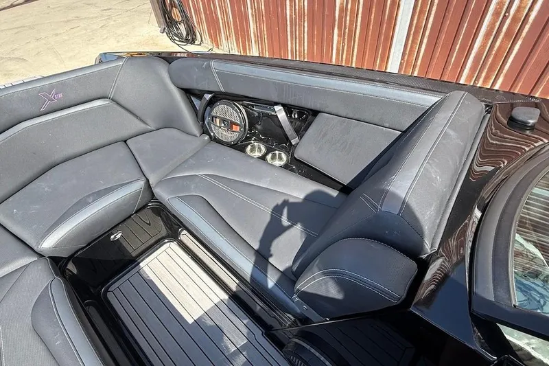 Slide: The Image of 2023 MasterCraft XStar S Piranha boat interior with sleek seating and premium audio system. - 11