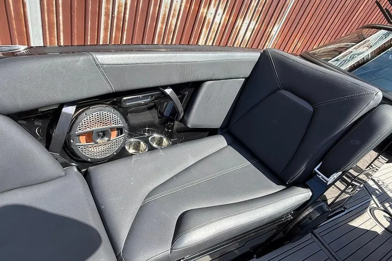 Slide: The Image of 2023 MasterCraft XStar S Piranha boat interior with sleek seating and premium speaker system. - 12