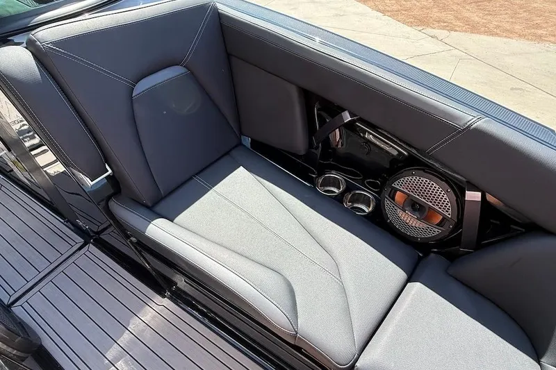 Slide: The Image of 2023 MasterCraft XStar S Piranha interior with sleek seating and built-in speaker system. - 13