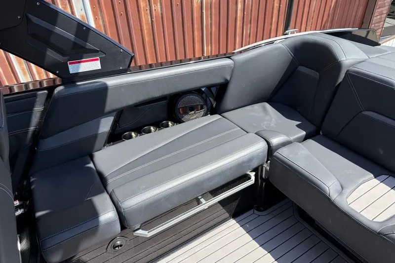 Slide: The Image of 2023 MasterCraft XStar S Piranha interior with sleek black seating and cup holders. - 16