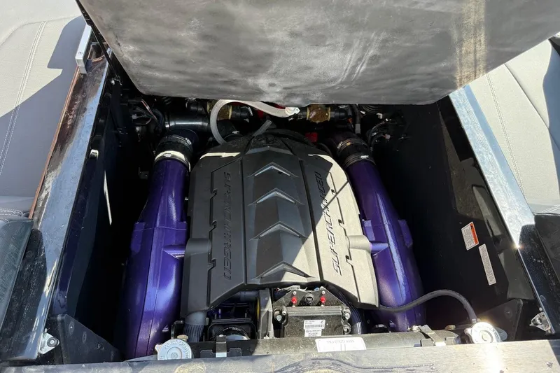 Slide: The Image of 2023 MasterCraft XStar S Piranha engine compartment with visible components and purple accents. - 18