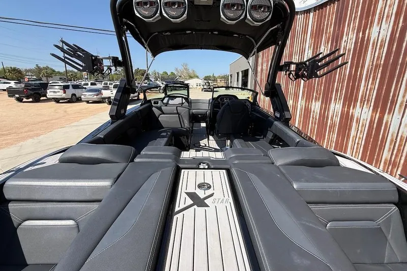 Slide: The Image of 2023 MasterCraft XStar S Piranha boat interior with sleek seating and advanced audio system. - 4