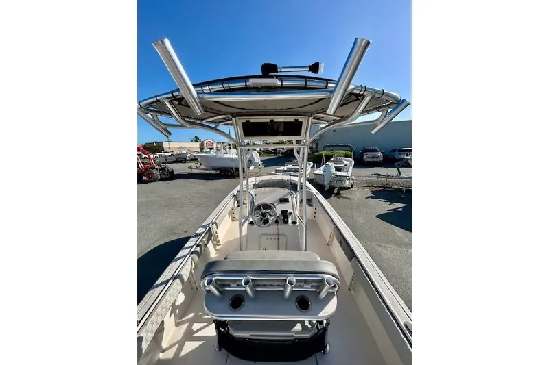 Slide: The Image of 2026 Carolina Skiff 21 Ultra Elite boat with T-top and console, parked outdoors. - 10
