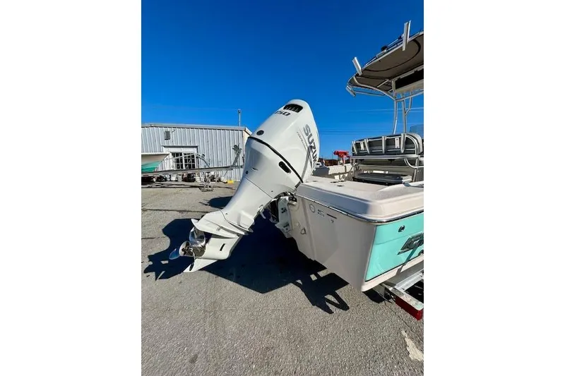 Slide: The Image of 2026 Carolina Skiff 21 Ultra Elite boat with Suzuki outboard motor, parked outdoors. - 11