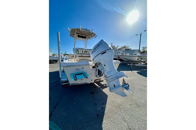 Slide: The Image of 2026 Carolina Skiff 21 Ultra Elite boat with Suzuki outboard motor in sunny marina. - 12