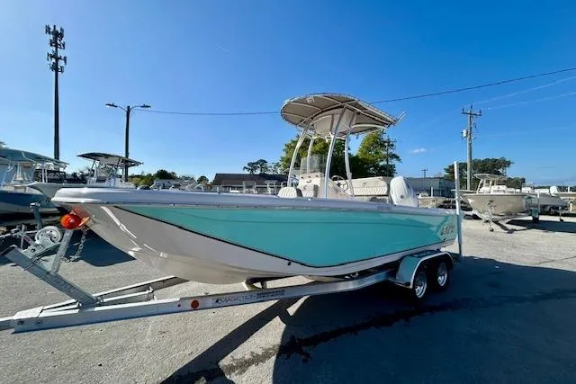 Slide: The Image of 2026 Carolina Skiff 21 Ultra Elite boat on trailer, turquoise hull, sunny day. - 4