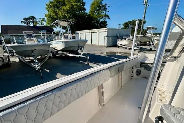 Slide: The Image of 2026 Carolina Skiff 21 Ultra Elite boat in a marina with other boats. - 5