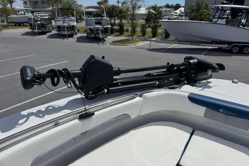 Slide: The Image of 2023 Robalo R202 Explorer boat with Garmin trolling motor in a marina parking lot. - 11