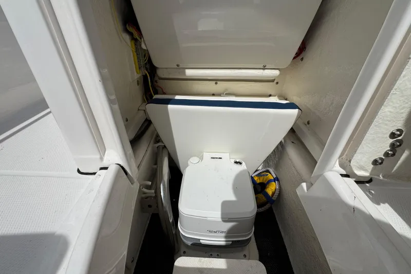 Slide: The Image of 2023 Robalo R202 Explorer boat interior with compact marine toilet. - 20