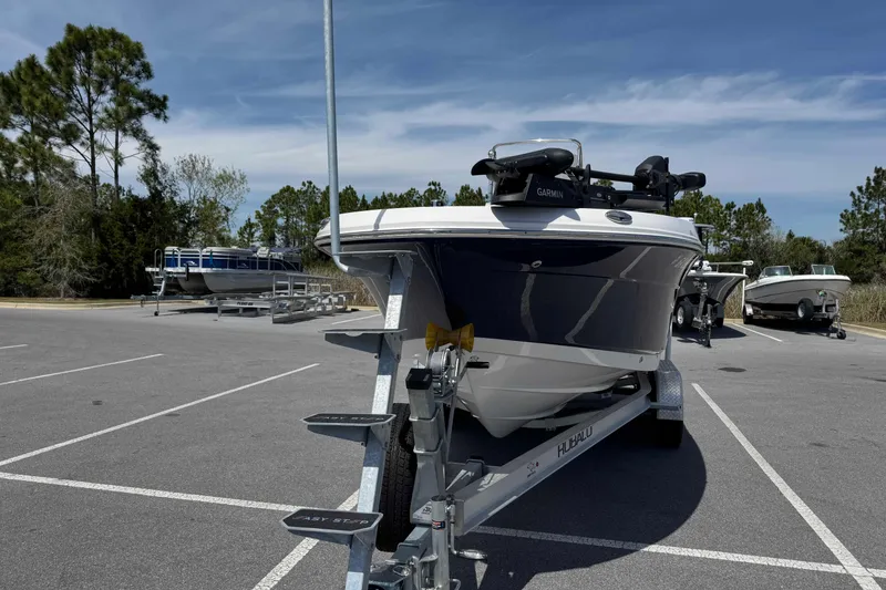 Slide: The Image of 2023 Robalo R202 Explorer boat on trailer in parking lot under clear sky. - 8