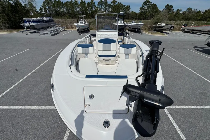 Slide: The Image of 2023 Robalo R202 Explorer boat in parking lot, showcasing sleek design and seating. - 9
