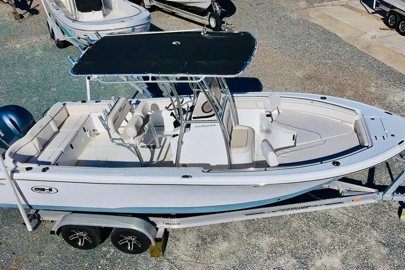 Slide: The Image of 2022 Sea Hunt Ultra 234 boat on trailer, featuring spacious seating and sleek design. - 10