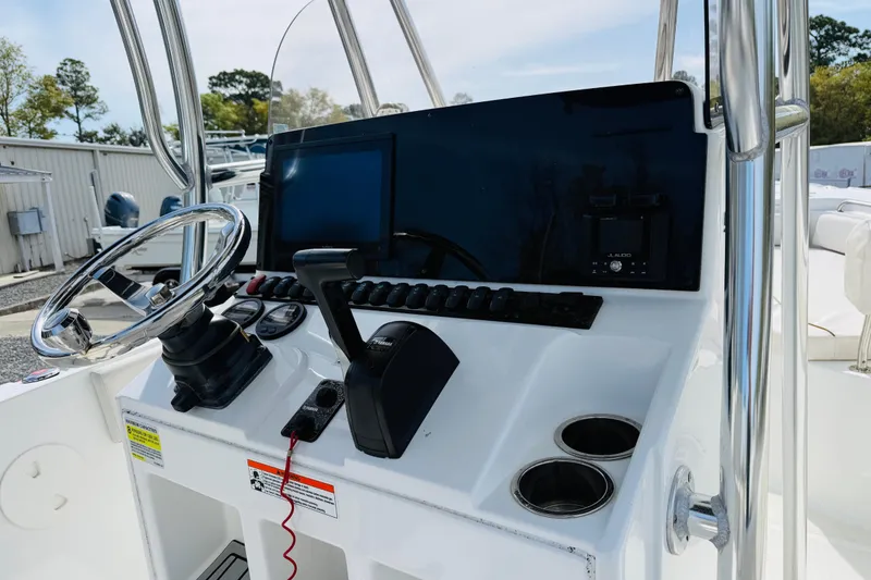Slide: The Image of 2022 Sea Hunt Ultra 234 boat console with steering wheel and controls. - 3
