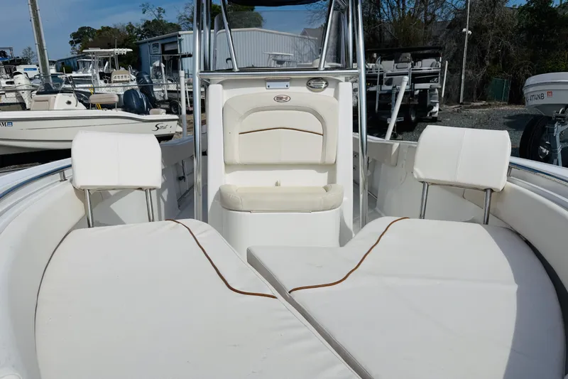 Slide: The Image of 2022 Sea Hunt Ultra 234 boat interior with white seating and console. - 5