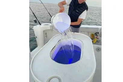 Slide: The Image of Person pouring water into livewell on 2004 Luhrs 38 Open boat. - 12